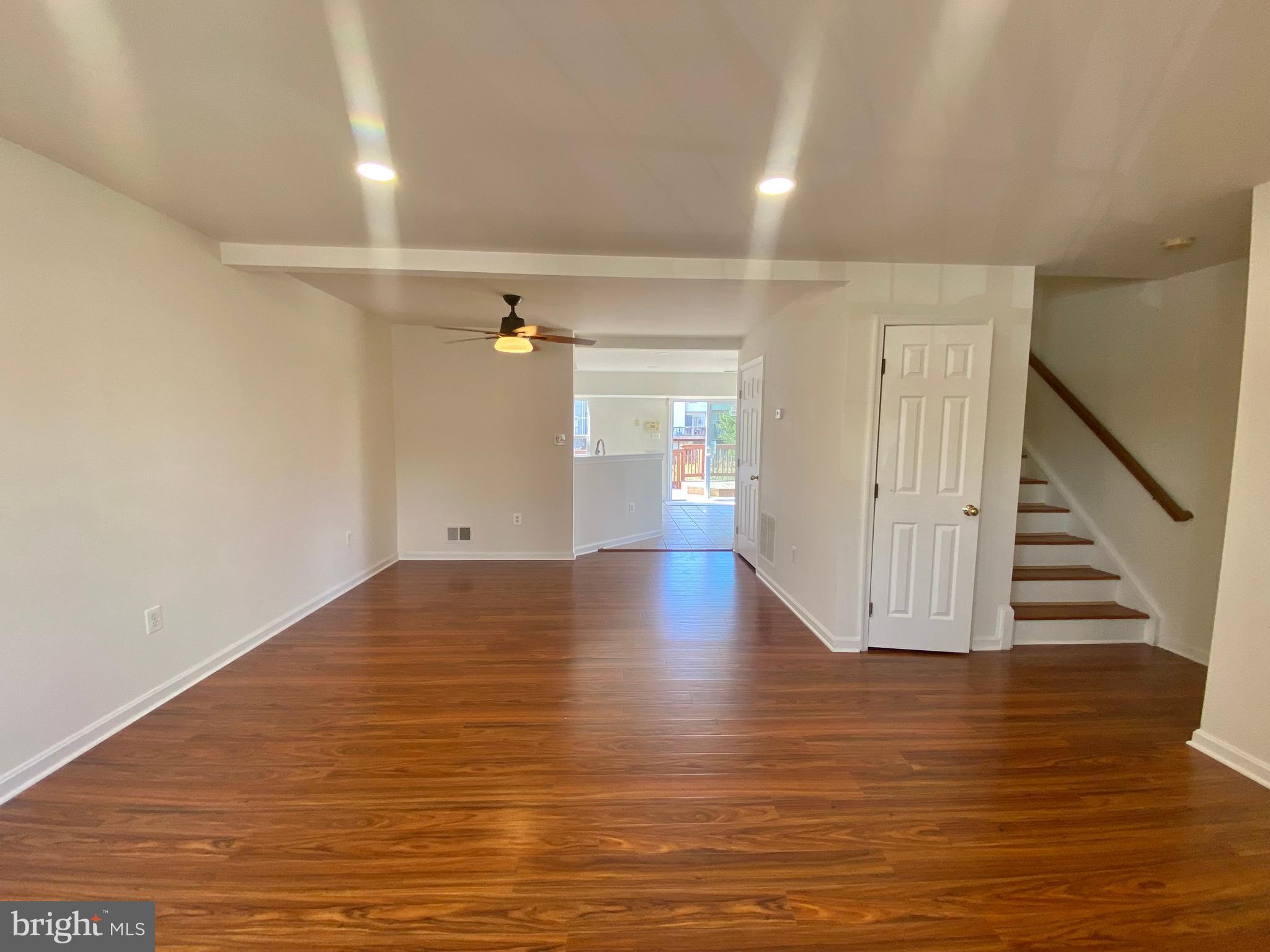 17324 Sligo Loop Dumfries, VA 22026 - Photo 9 of 39 a view of an empty room with wooden floor and staircase