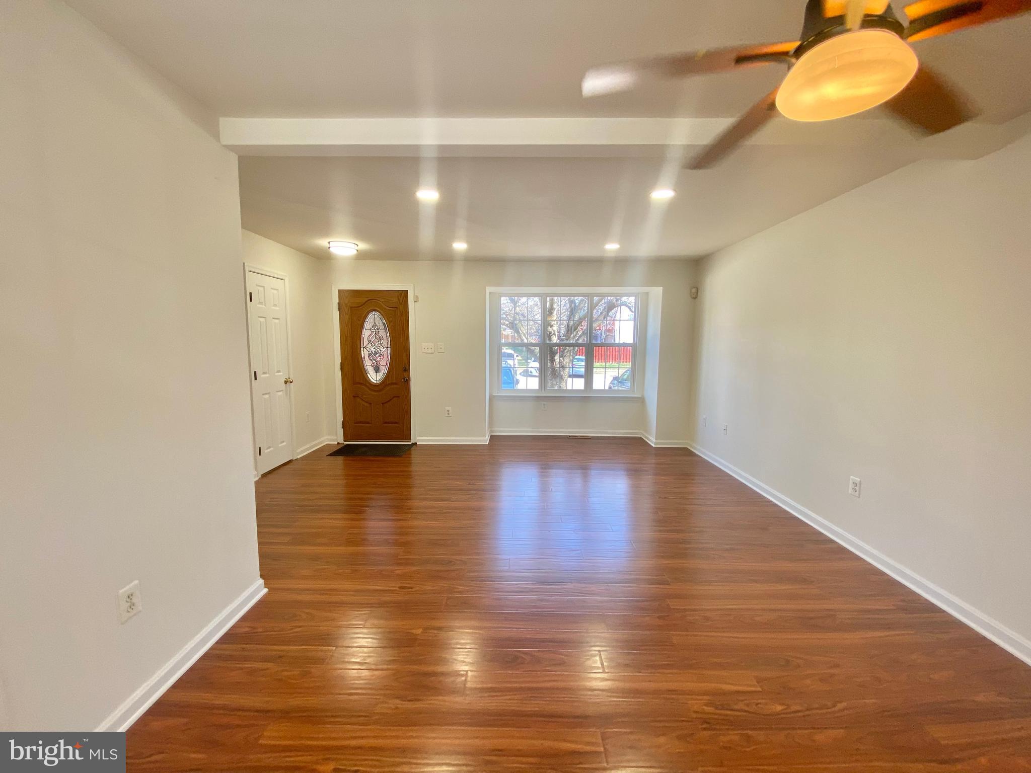 17324 Sligo Loop Dumfries, VA 22026 - Photo 10 of 39 an empty room with wooden floor and windows