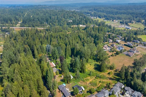 a view of a field with trees in the background