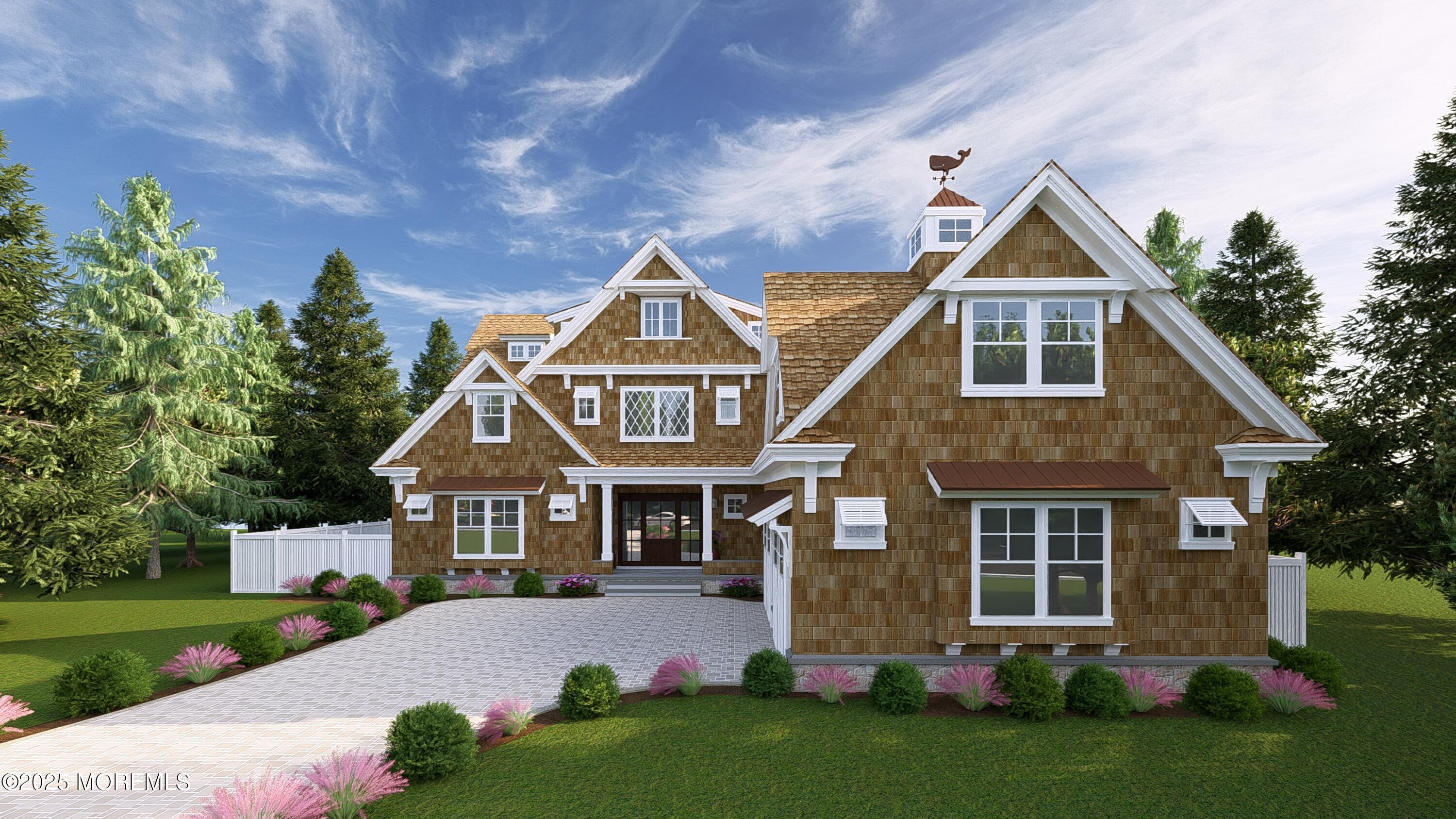 a front view of a house with a yard and trees