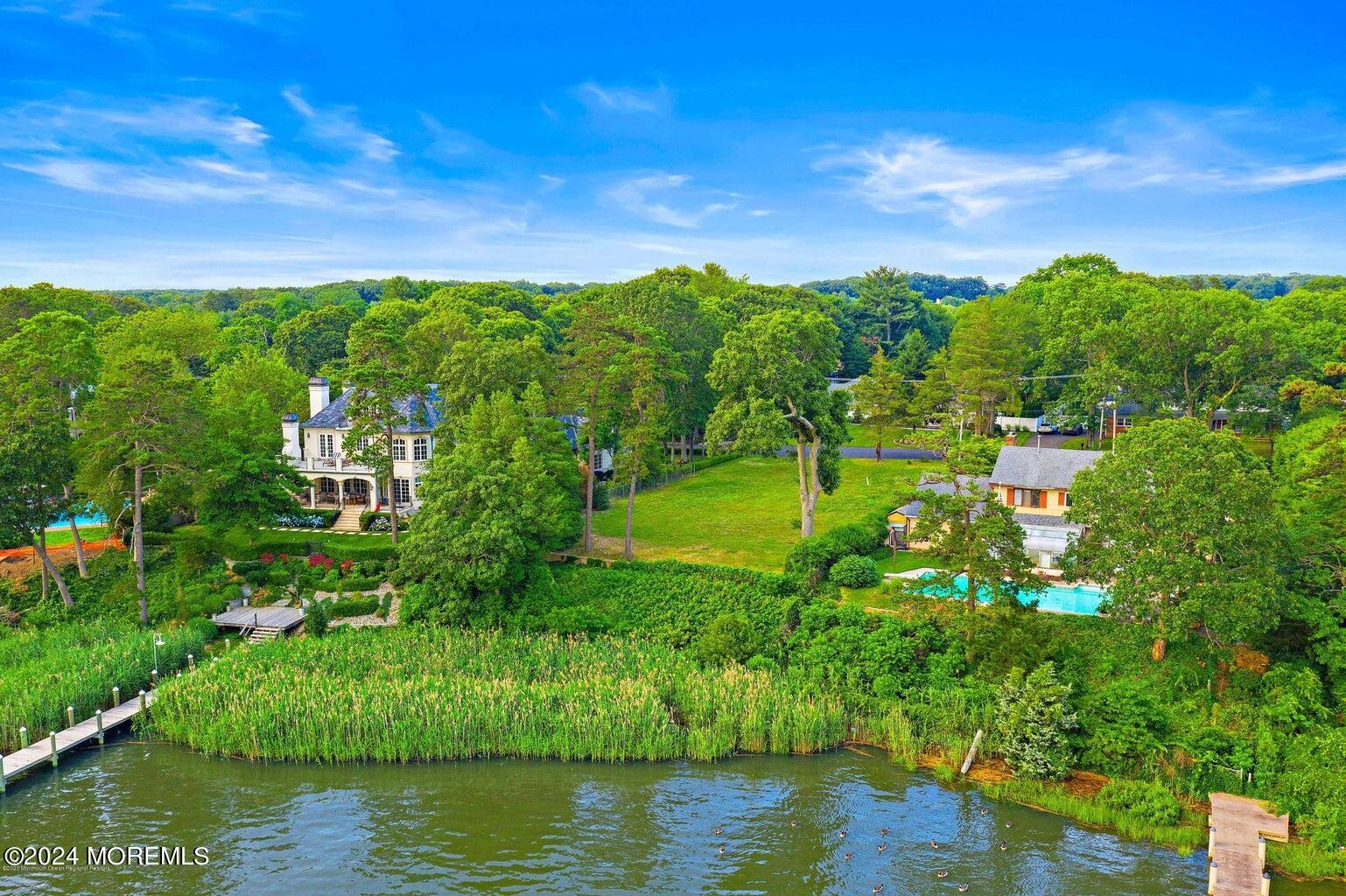 2639 River Road Manasquan, NJ 08736 - Photo 12 of 15 a view of a lake with houses in the background