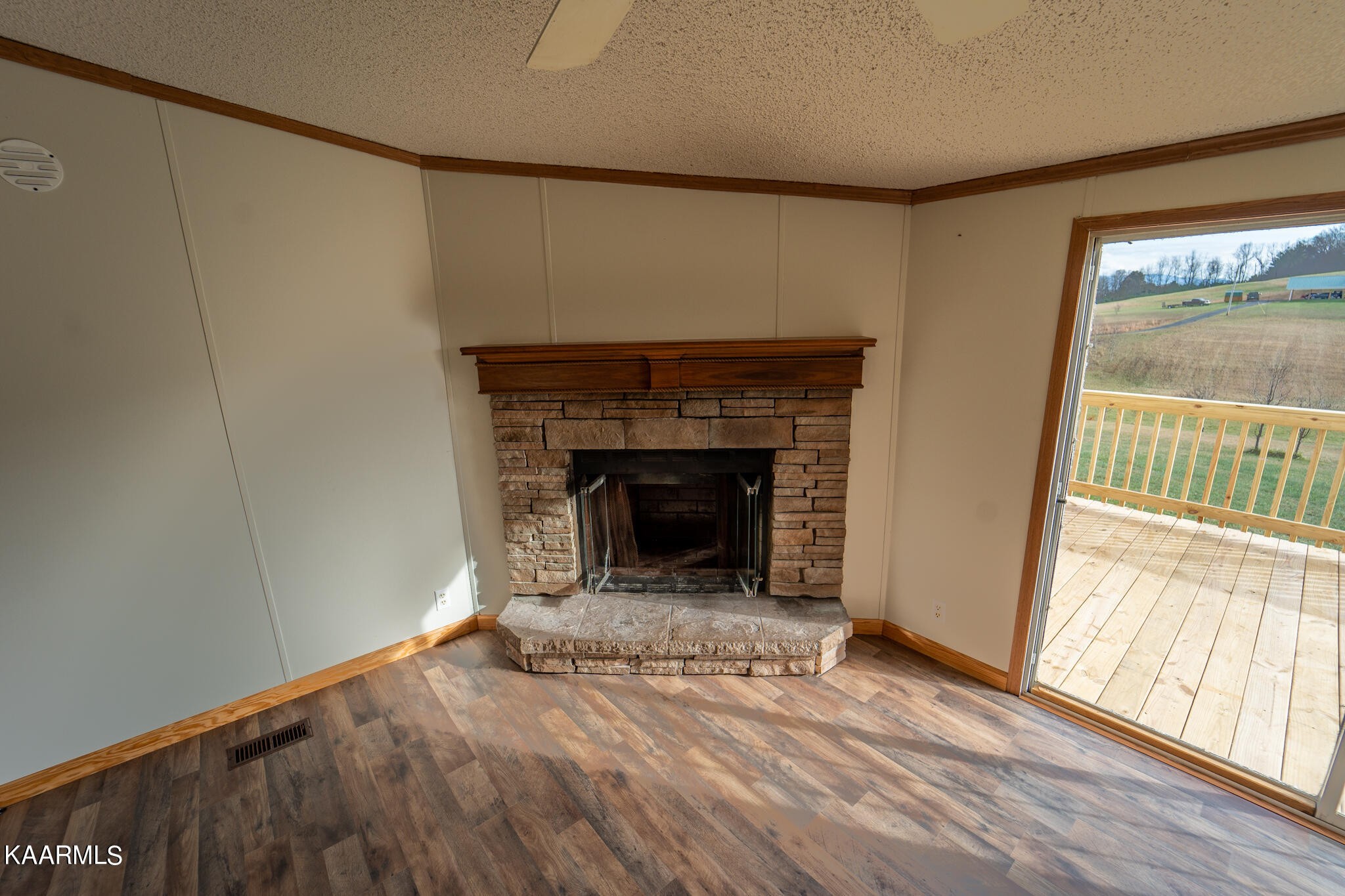 560 Meadowview Road Mosheim, TN 37818 - Photo 3 of 23 a view of an empty room with wooden floor and a window