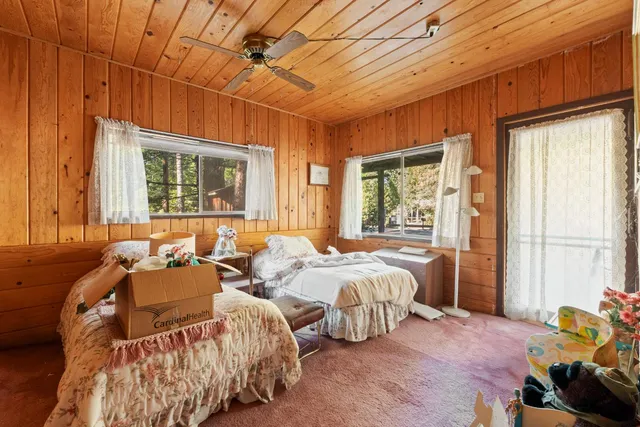 a bed room with two beds and a window