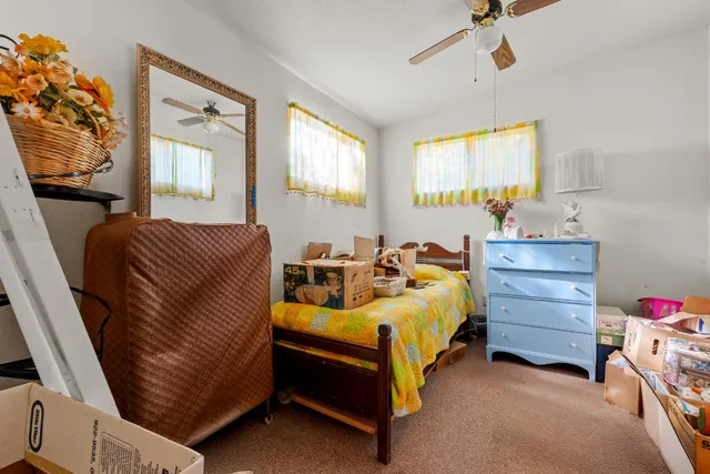 a bed room with a bed and a window