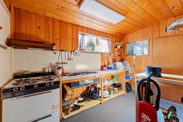 a kitchen with stainless steel appliances a stove a sink and a microwave