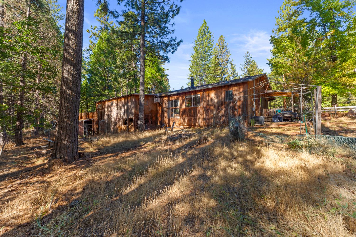 5983 Sly Park Road Placerville, CA 95667 - Photo 24 of 36 a view of a yard with wooden fence and a bench