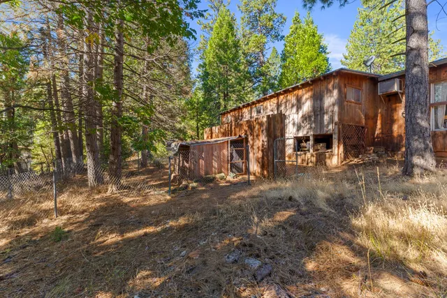 a view of a house with large trees