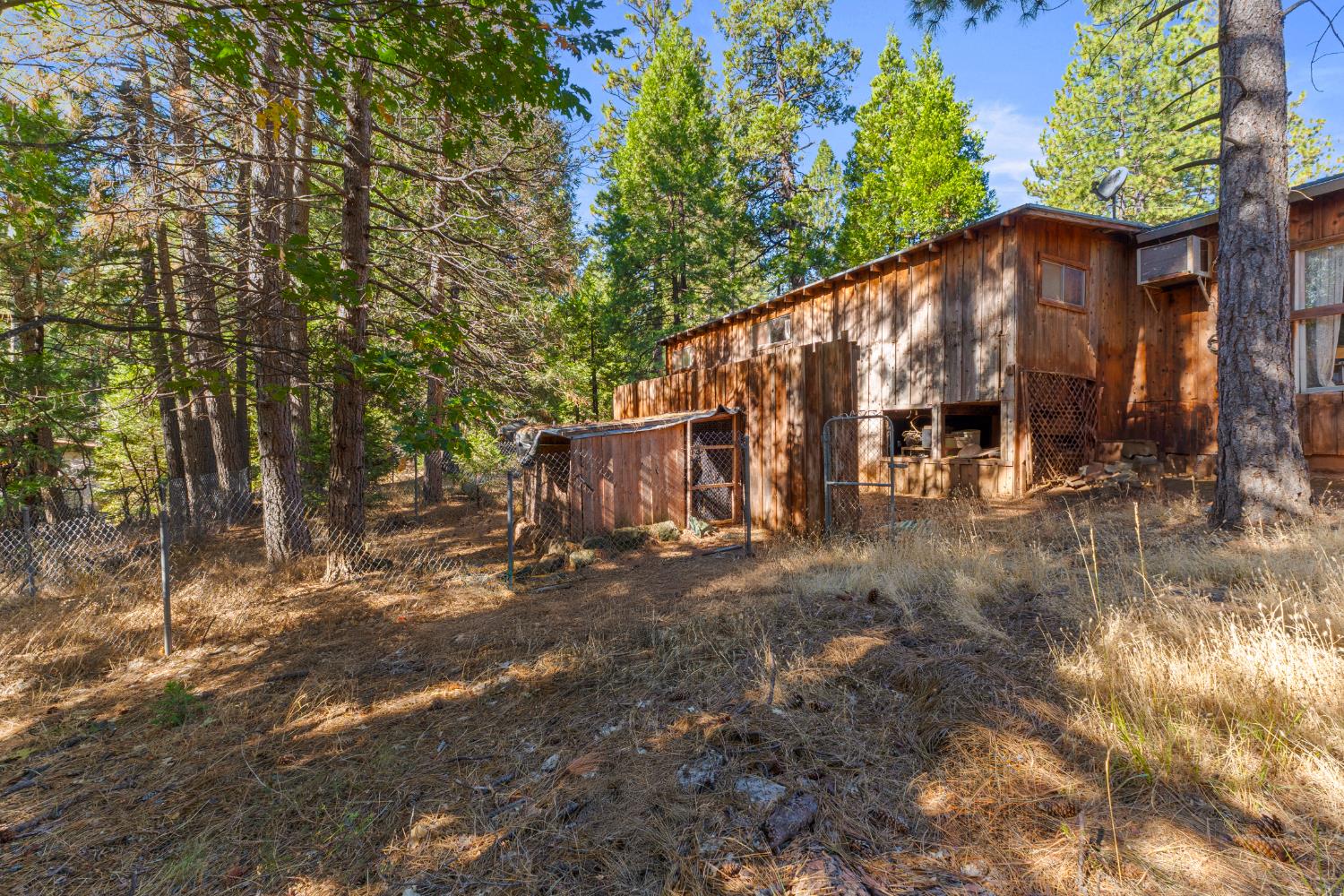 5983 Sly Park Road Placerville, CA 95667 - Photo 29 of 36 a view of a house with large trees