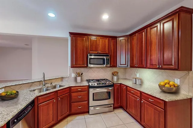 a kitchen with wooden cabinets and sink