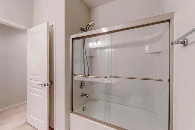 a bathroom with a glass shower door
