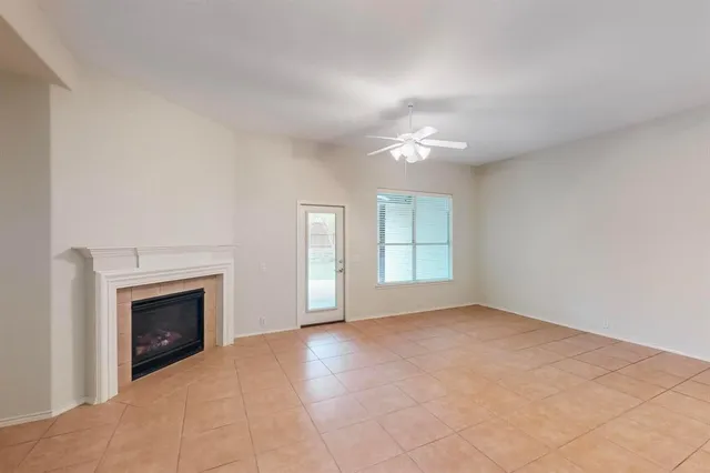 a view of empty room with a fireplace