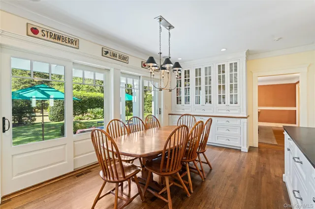 a view of a dining room with furniture large windows and wooden floor