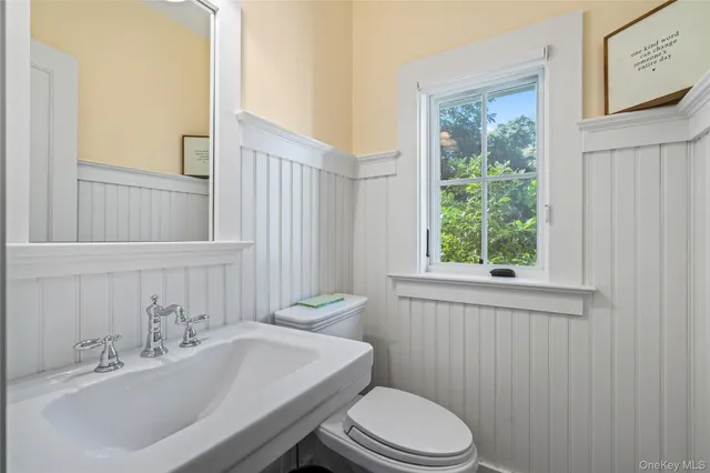 a bathroom with a sink a toilet and tub