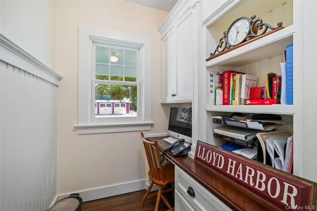 a view of a workspace with furniture and a window