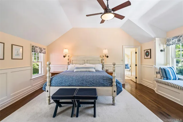 a living room with a bed furniture and a chandelier