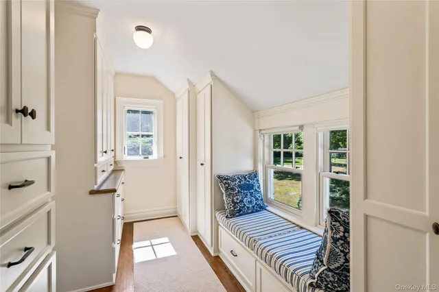 a view of a hallway with wooden floor and stairs