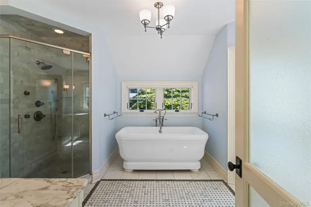 a spacious bathroom with a bathtub and shower