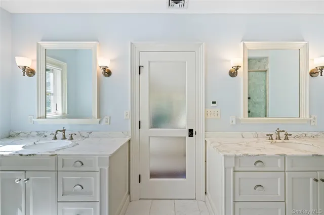 a bathroom with a shower sink vanity and mirror