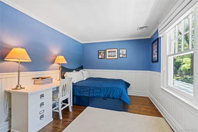 a living room with a bed furniture and a large window