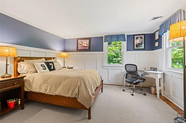 a bedroom with a bed chair and a window