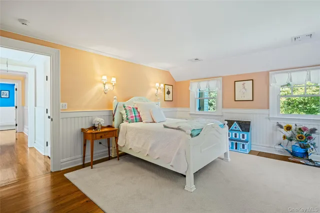 a spacious bedroom with a bed and a table in it