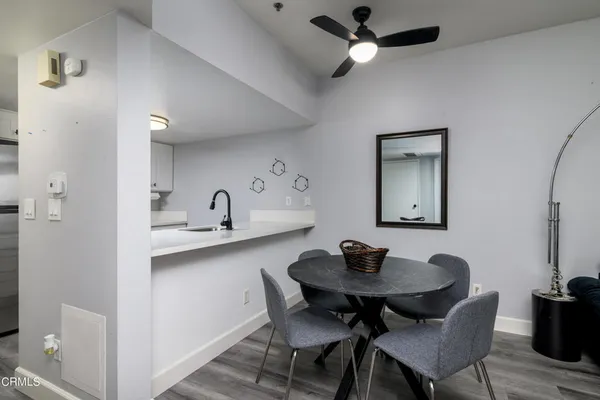 a view of a dining room with furniture and a chandelier fan