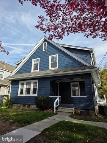 a brick house with garden in front of it
