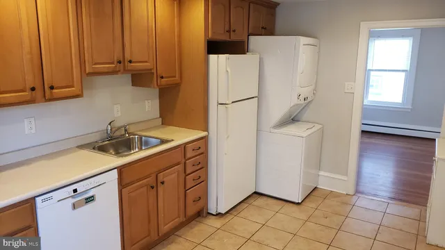 a room with a refrigerator and cabinets