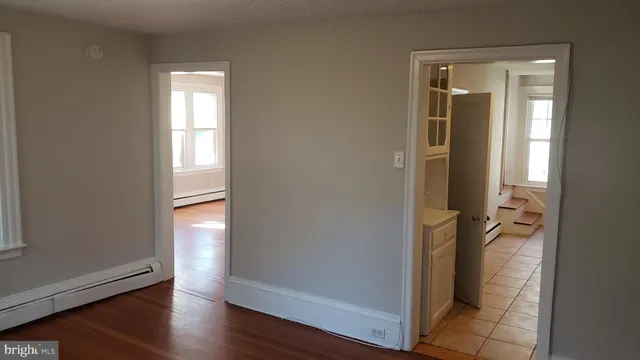 an empty room and wooden floor with windows