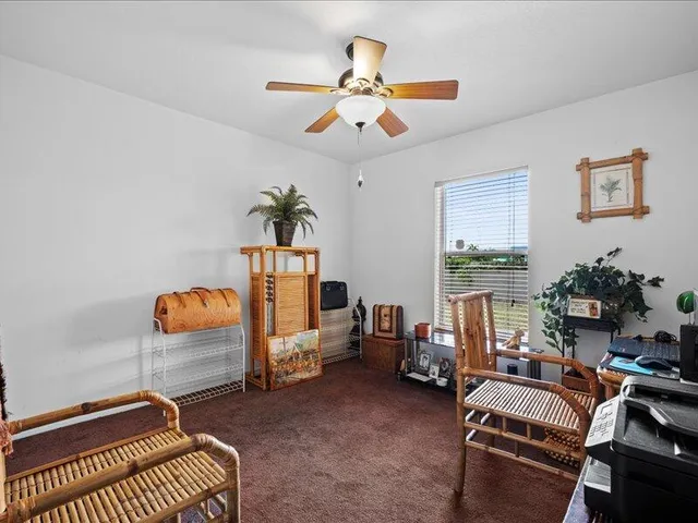 a living room with furniture a air conditioner and a window