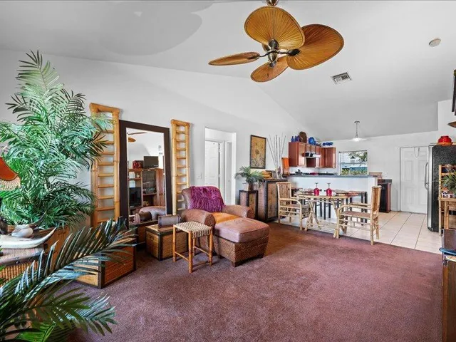 a living room with furniture gym equipment and a chandelier