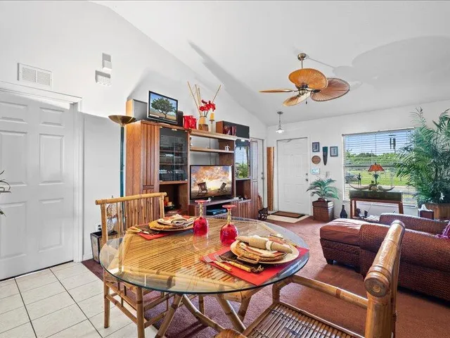 a living room with furniture a rug and a chandelier