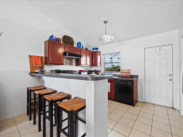 a kitchen with stainless steel appliances granite countertop a stove and a refrigerator
