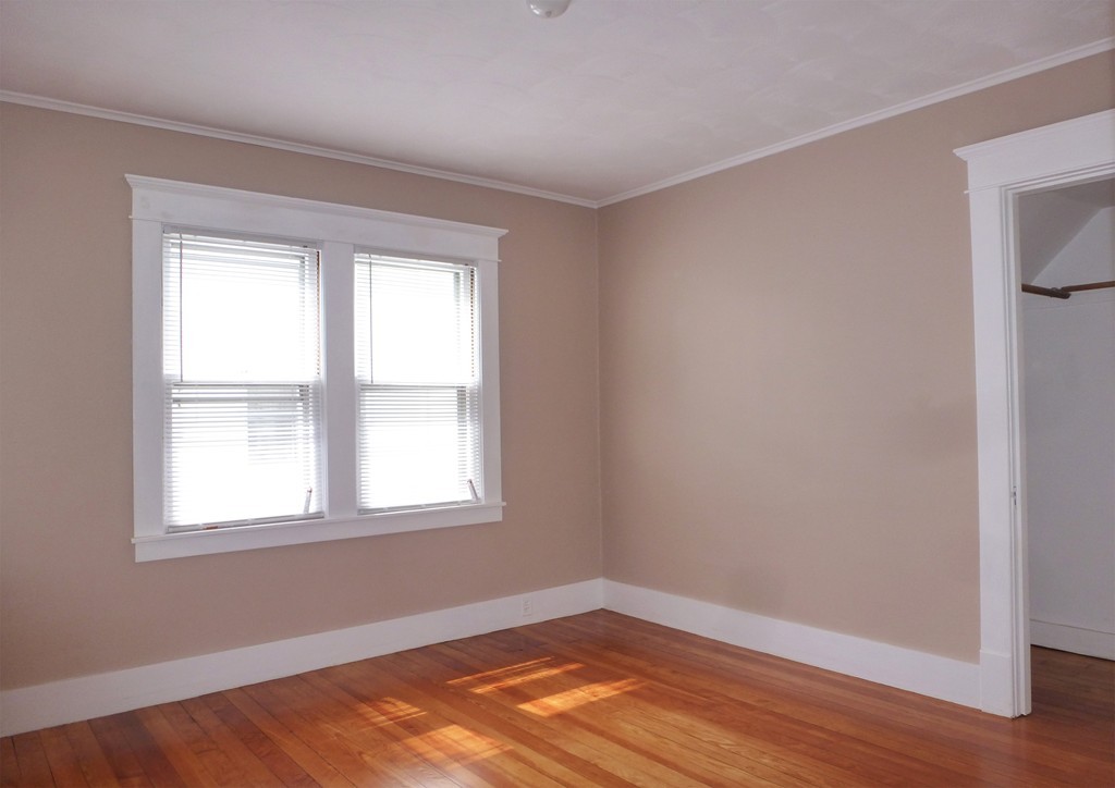 95-97 Dwight Road Springfield, MA 01108 - Photo 11 of 19 an empty room with wooden floor and windows