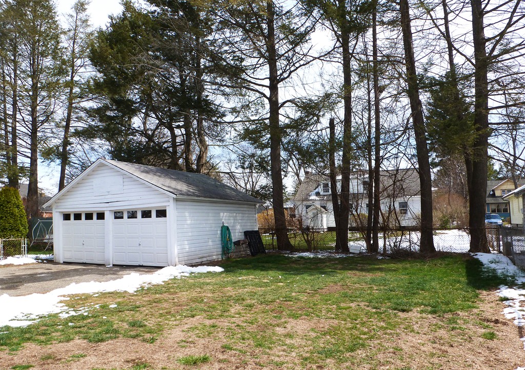 95-97 Dwight Road Springfield, MA 01108 - Photo 3 of 19 a front view of a house with a garden and trees