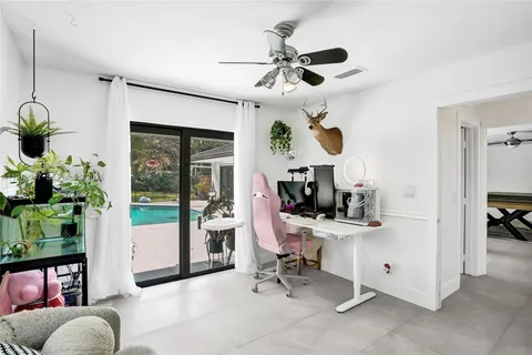 a view of a livingroom with workspace and a window