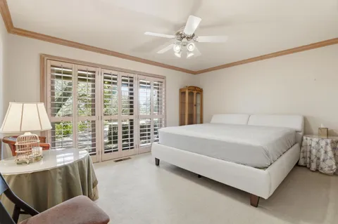 a bed room with a bed and a chandelier