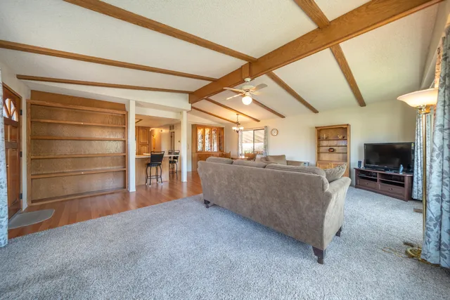 a living room with furniture wooden floor and a flat screen tv
