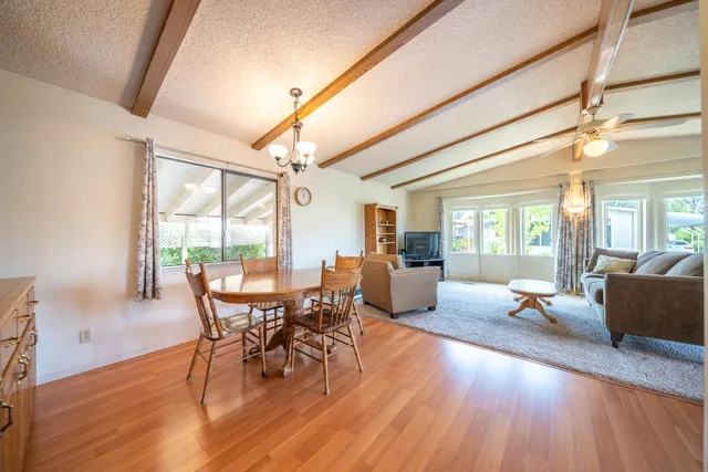 a dining room with furniture and wooden floor