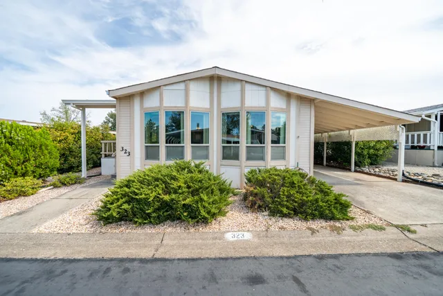 a view of a house with a small yard and plants