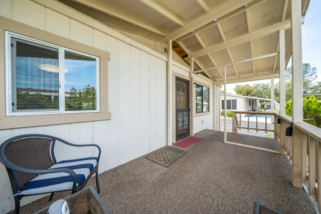 a view of a porch with furniture and front door