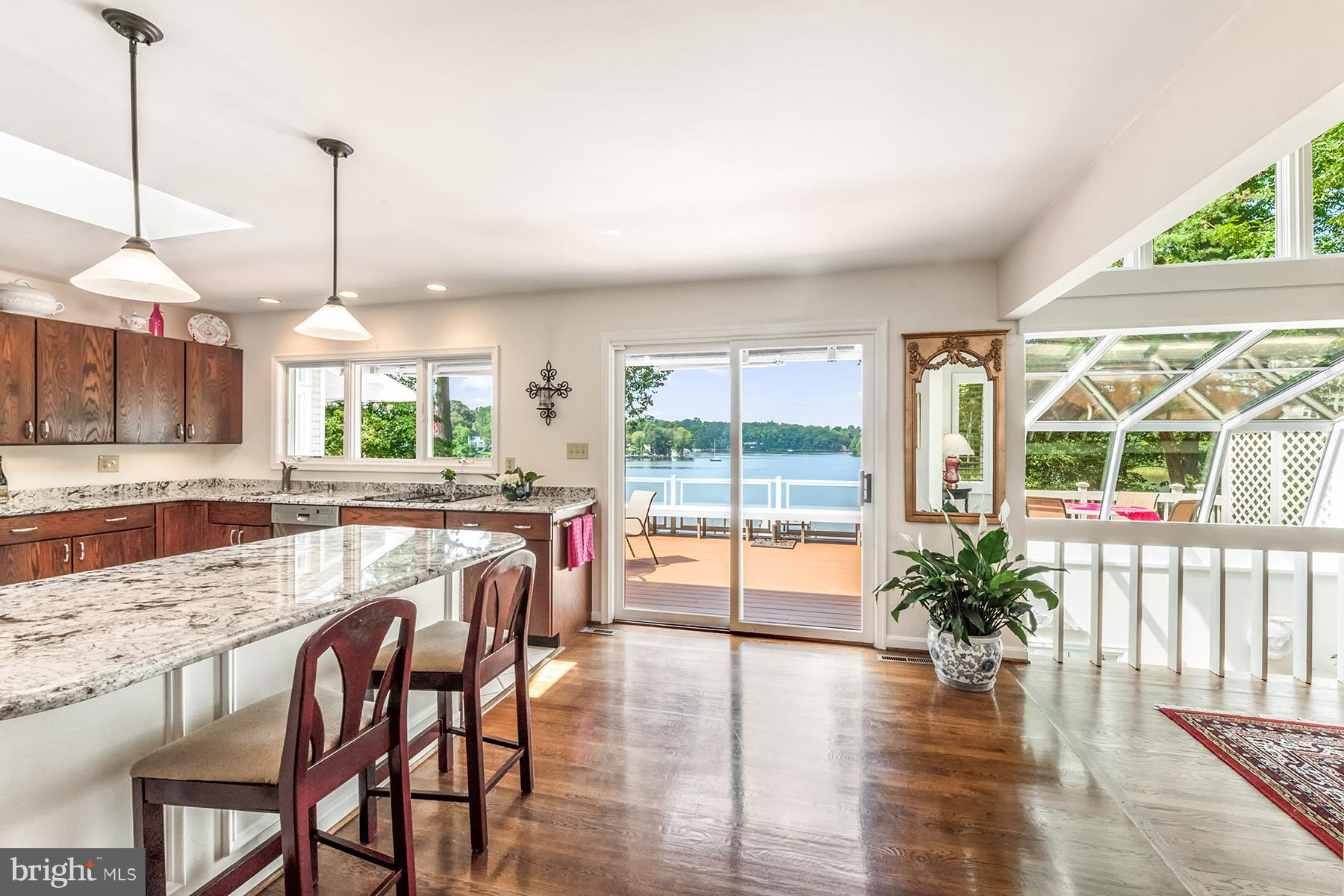 184 Southdown Road Edgewater, MD 21037 - Photo 6 of 30 Kitchen has a breakfast bar and sliders to deck