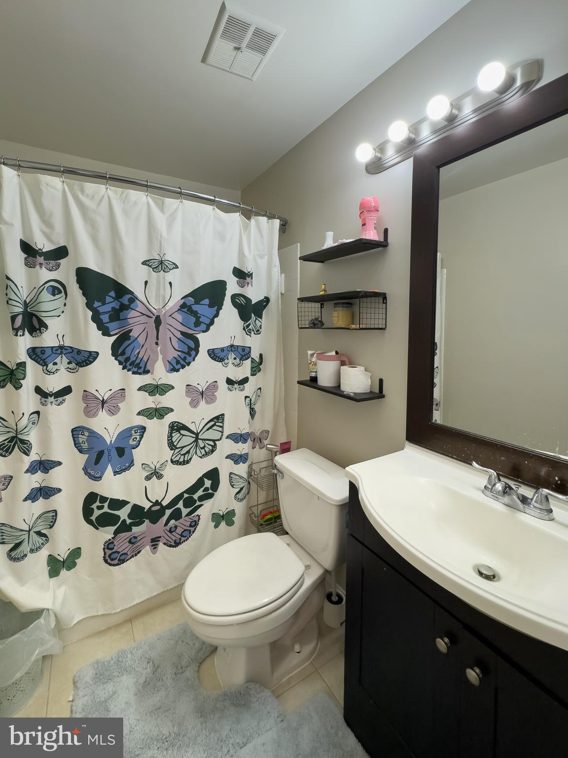 7416 Rokeby Drive Manassas, VA 20109 - Photo 5 of 17 a bathroom with a sink a toilet and shower curtain