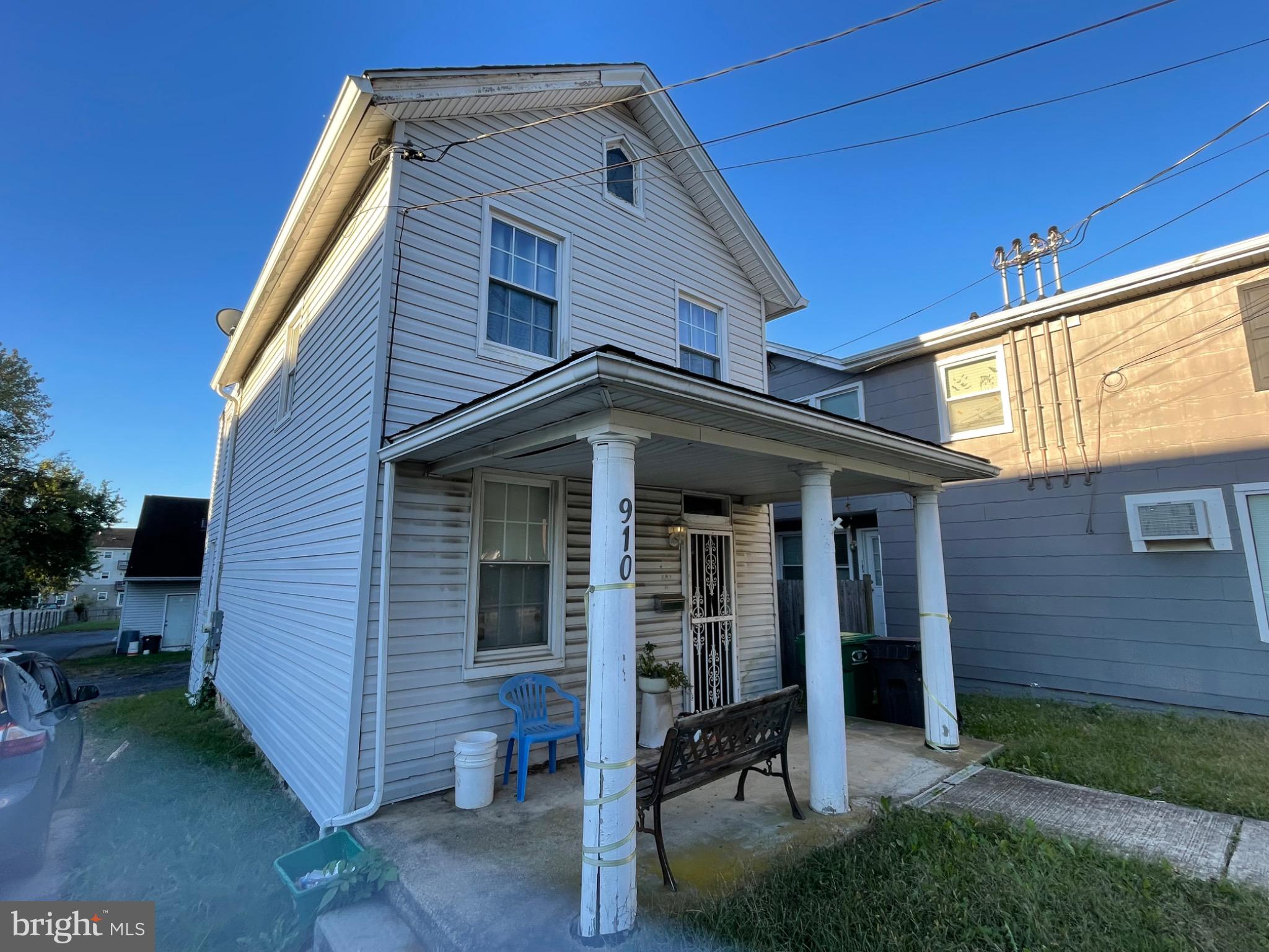 a view of a house with wooden walls and floor to ceiling window