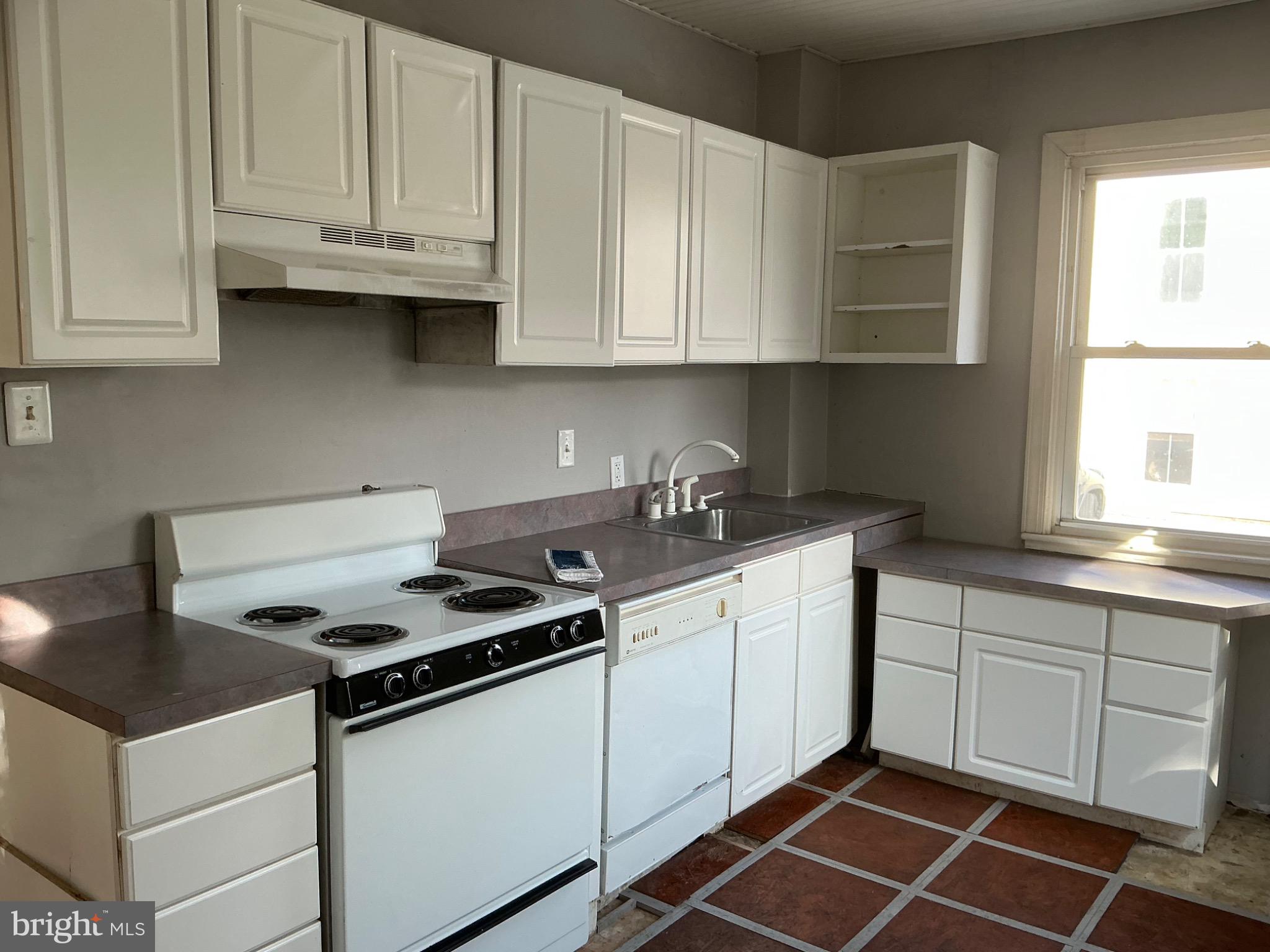 910 Montgomery Street, Unit A Laurel, MD 20707 - Photo 5 of 15 a kitchen with granite countertop a sink stove and cabinets