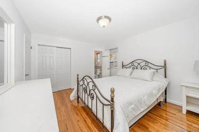 a bedroom with furniture and a wooden floor