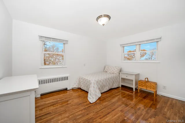 a workspace room with wooden floor and windows