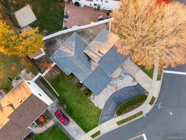 an aerial view of a house with a garden and mountain view