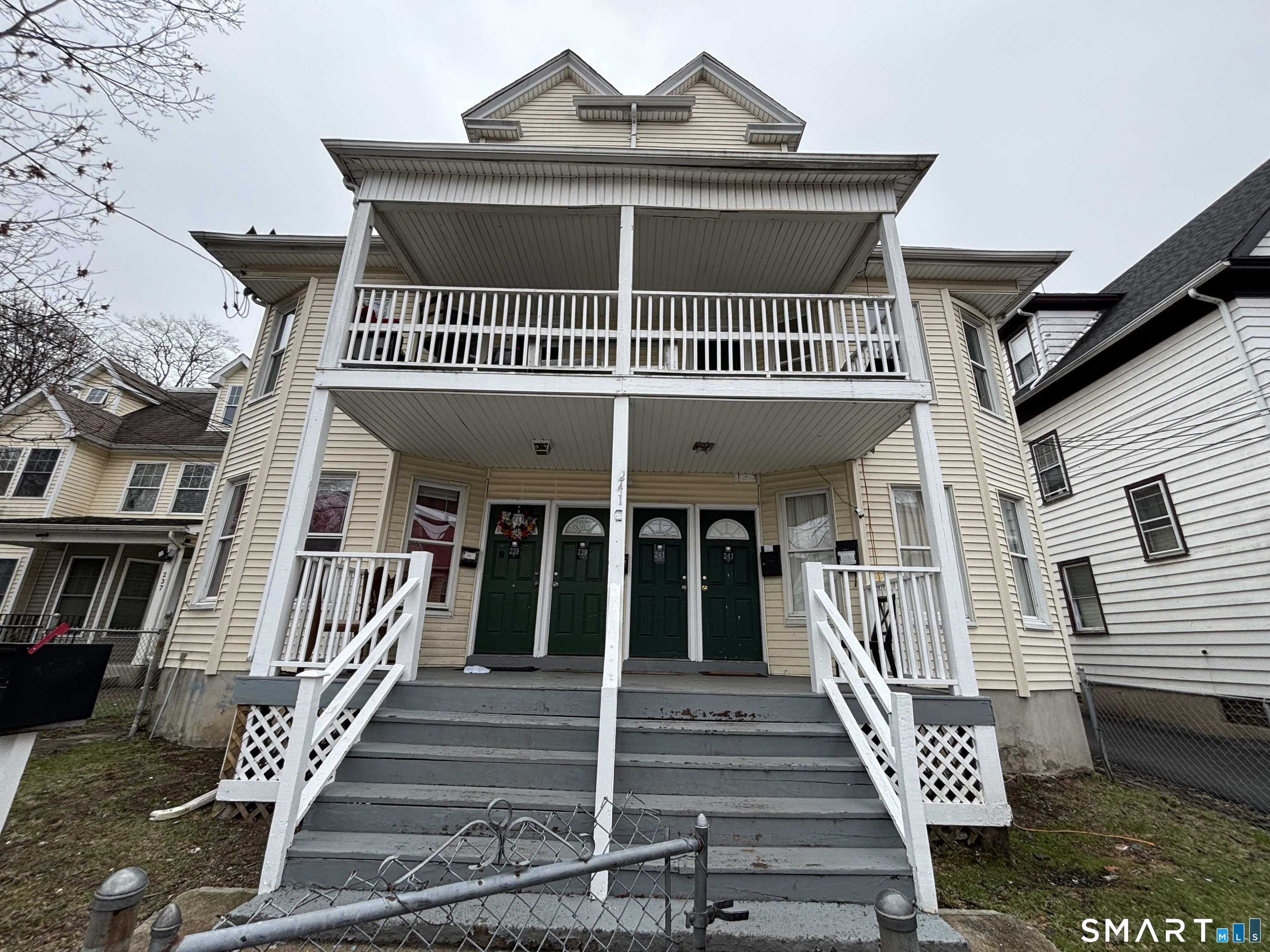 241 Lewis Street Bridgeport, CT 06605 - Photo 1 of 33 a front view of a house with a balcony