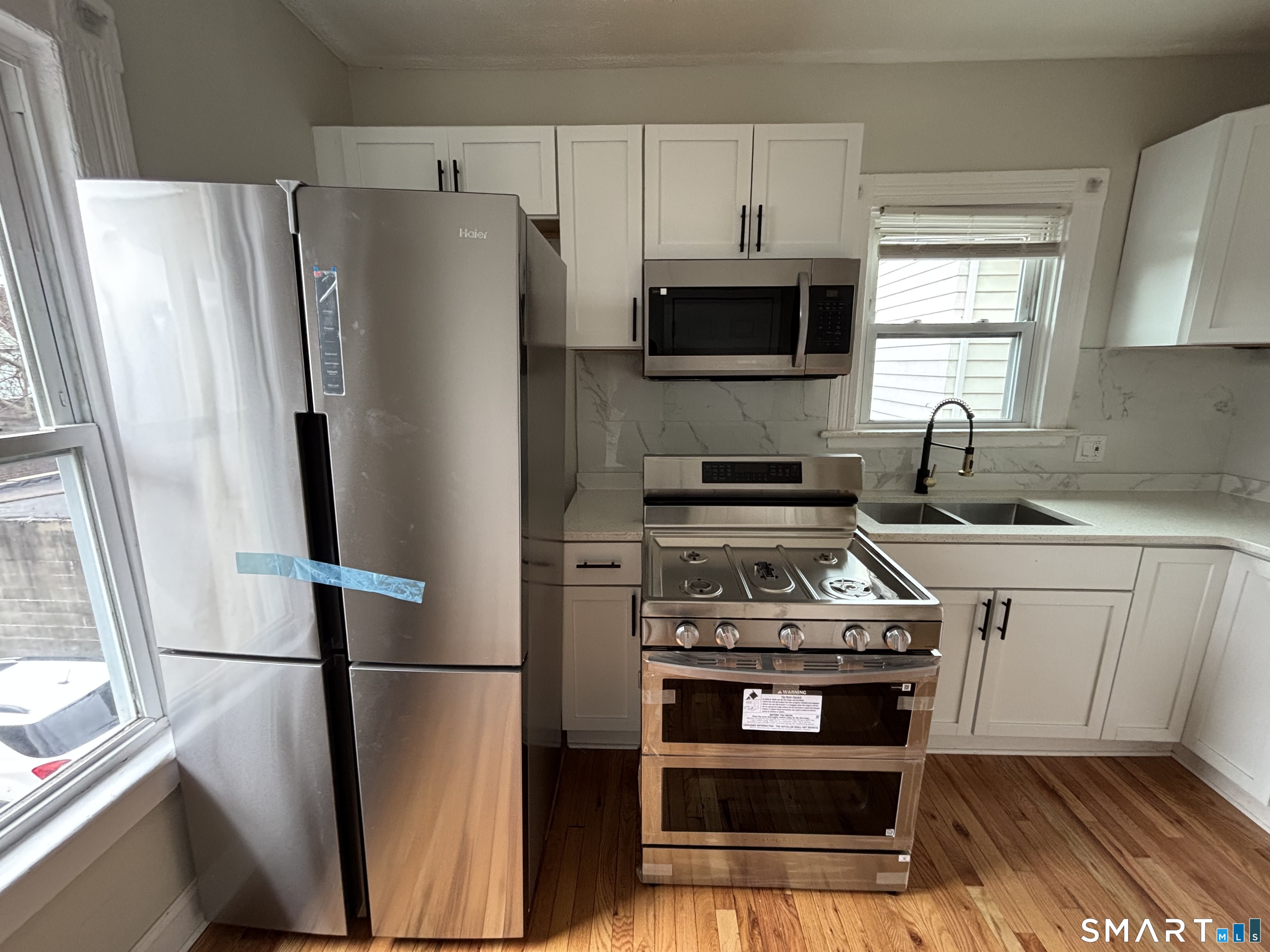 241 Lewis Street Bridgeport, CT 06605 - Photo 12 of 33 a kitchen with stainless steel appliances a refrigerator stove and sink